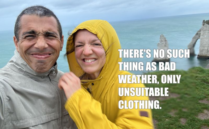 Gilles and a woman in a yellow raincoat on a windy sea cliff: “There's no such thing as bad weather, only unsuitable clothing.”